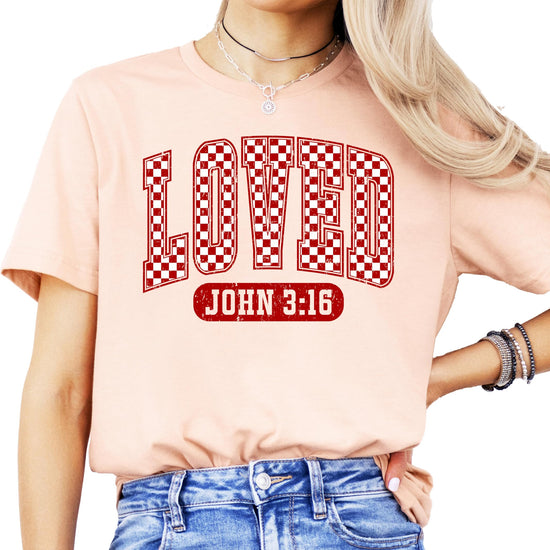 Detail shot of Loved John 3:16 Valentine's Day graphic tee in red checkered pattern