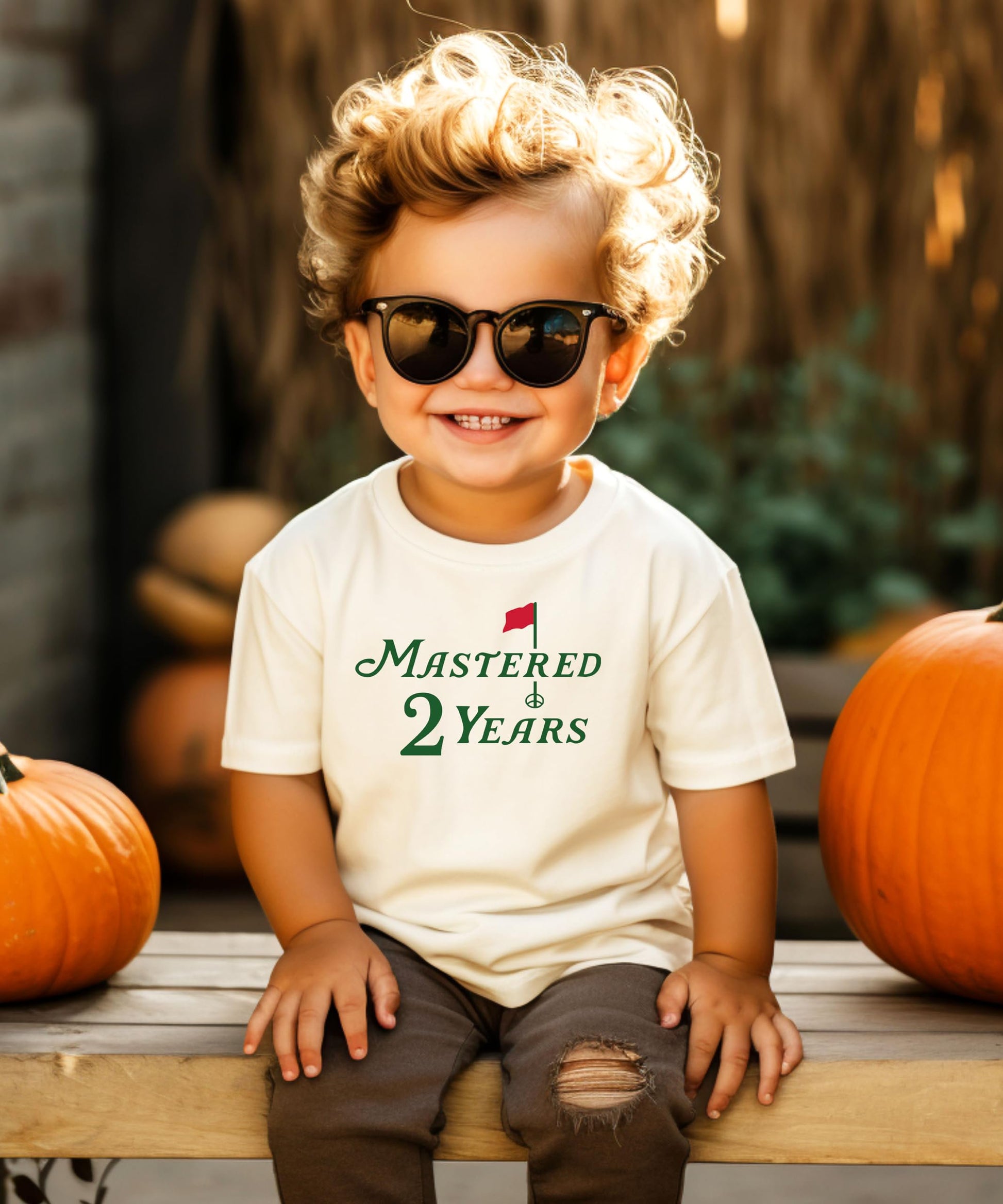 Toddler boys golf themed second birthday shirt laid flat on neutral background