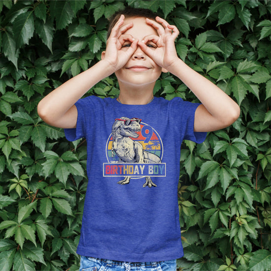Flat lay of kids 9th birthday dinosaur graphic tee with T-Rex in sunglasses design