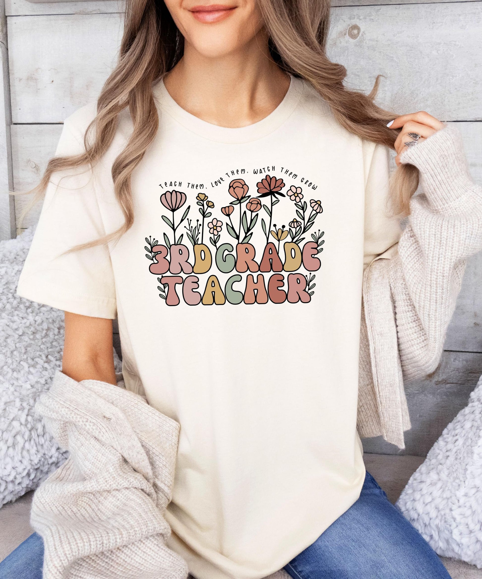 Back or alternate angle of women's peach floral teacher graphic tee from Olive Loves Apple