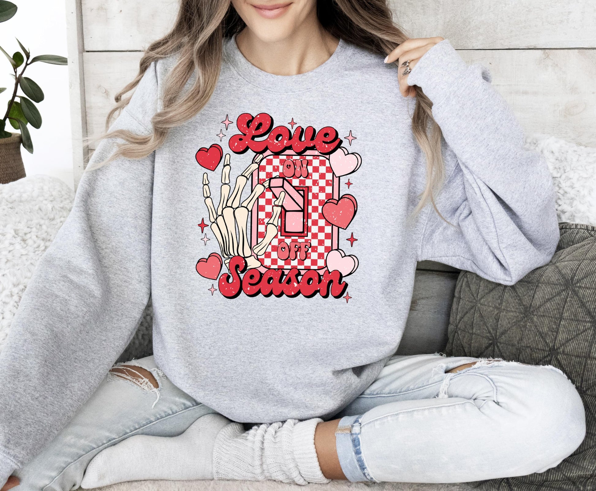 Flat lay of Olive Loves Apple Love Season Valentine's graphic sweatshirt showing fabric texture