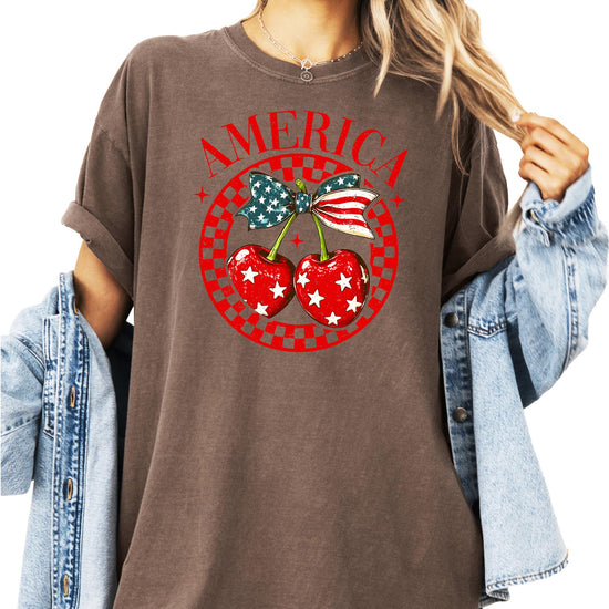 Woman wearing ivory patriotic cherry bow t-shirt with American flag elements