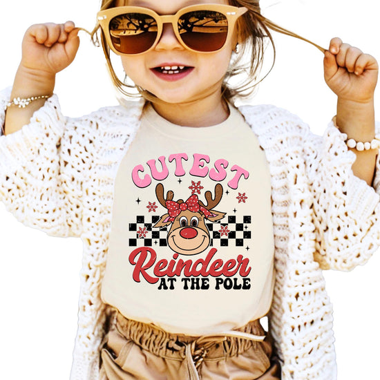 Front view of youth reindeer Christmas tee in natural color with festive holiday graphic print