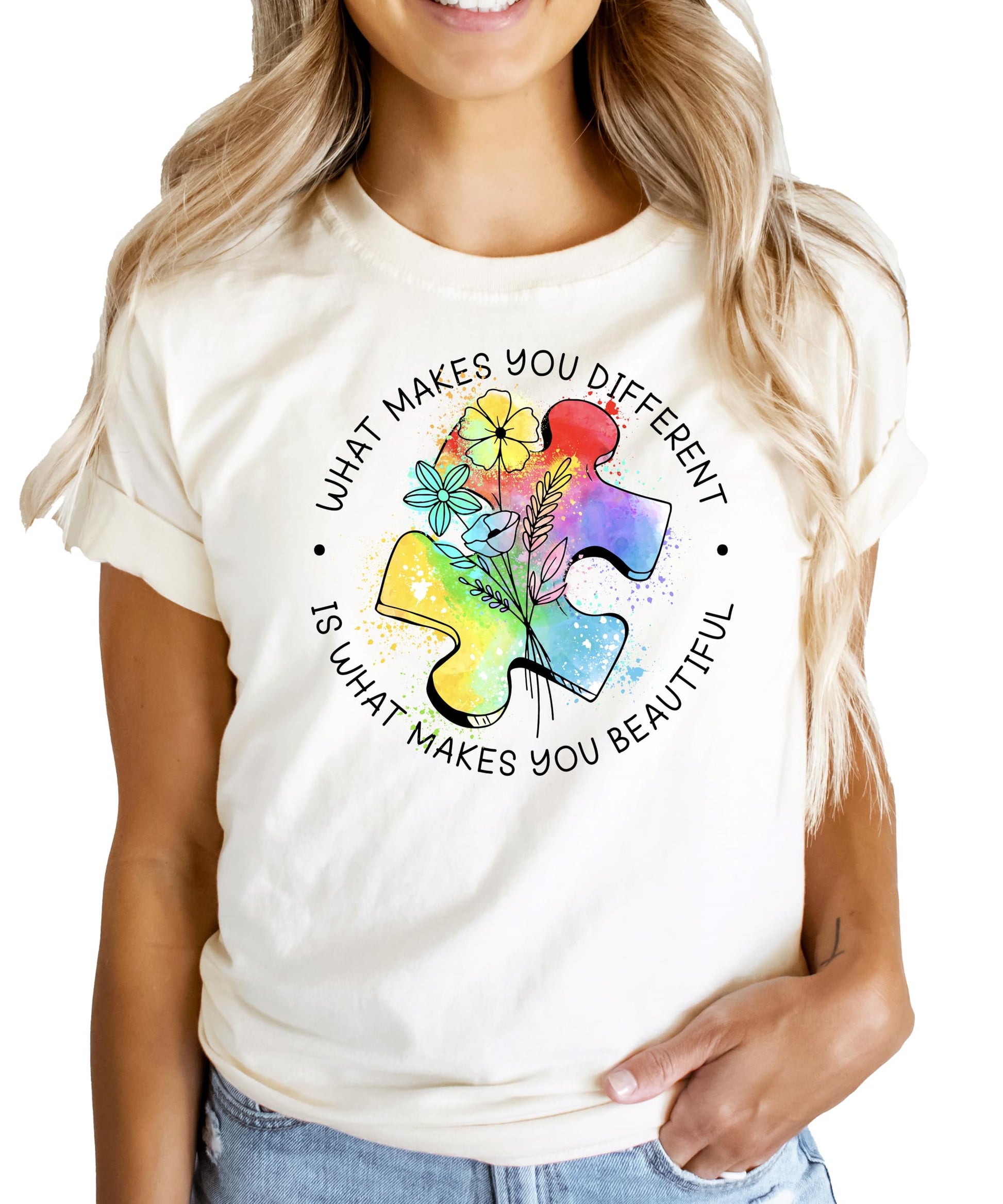 Close-up view of vibrant puzzle piece design with floral watercolor elements on pink shirt