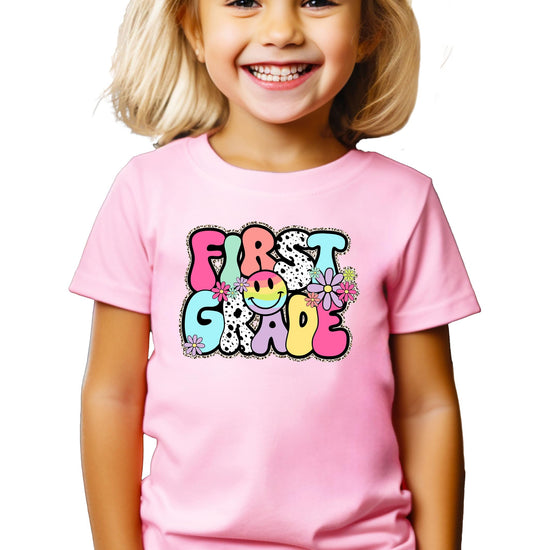 Girls first grade shirt flat lay showing full design and fit details