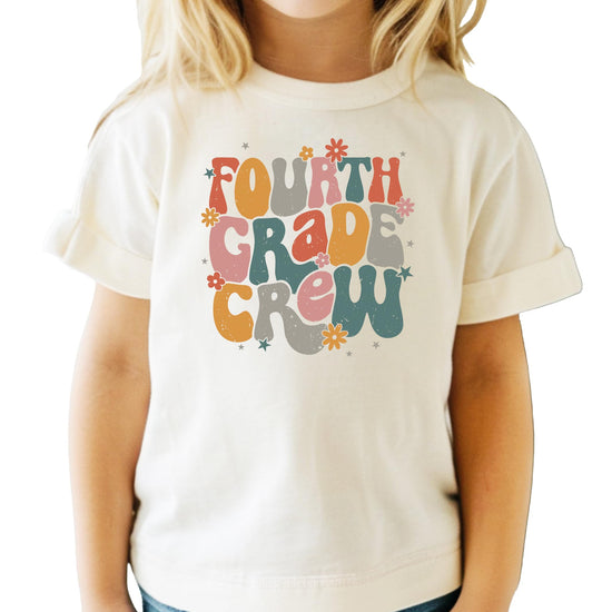 Fourth Grade Crew retro graphic t-shirt in peach with colorful text design