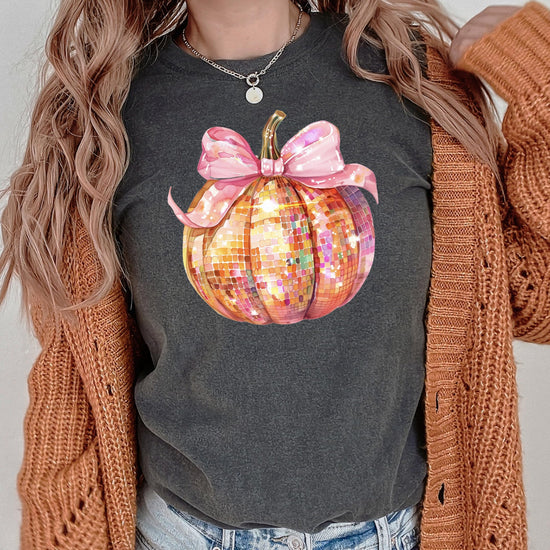 Lifestyle flat lay of coquette bow disco pumpkin fall shirt in seafoam green
