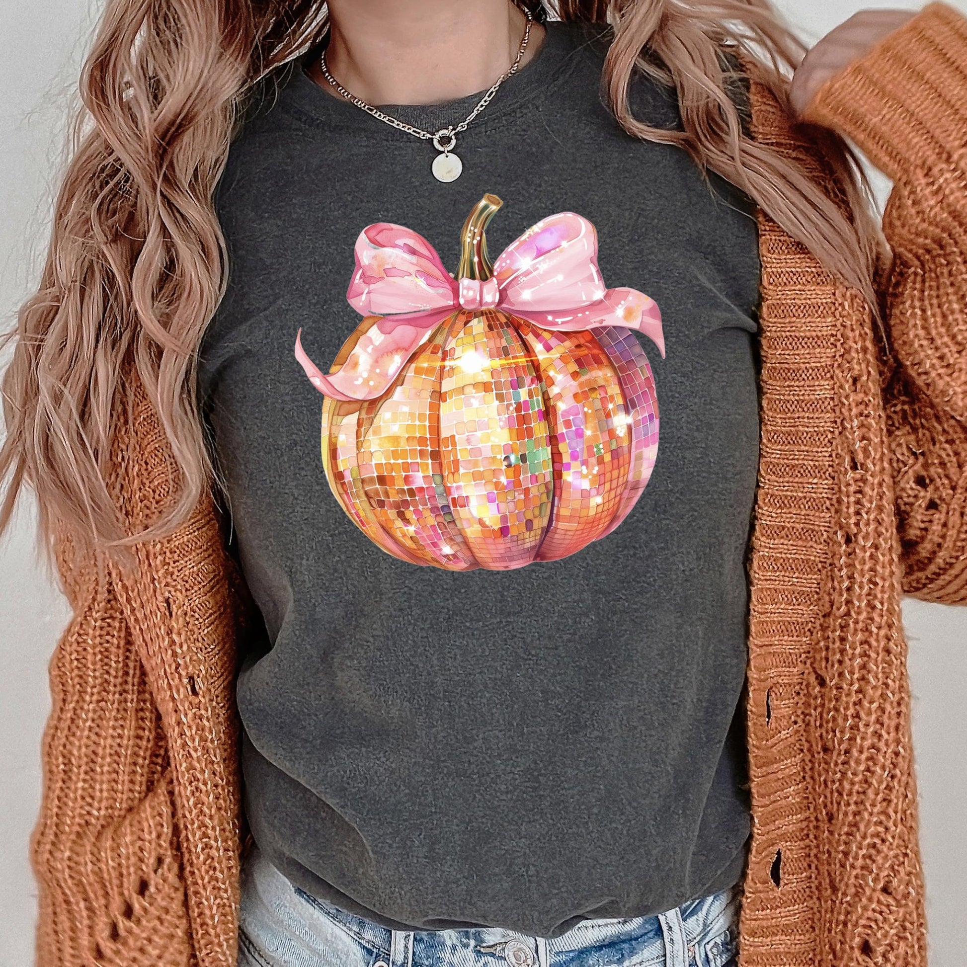Lifestyle flat lay of coquette bow disco pumpkin fall shirt in seafoam green