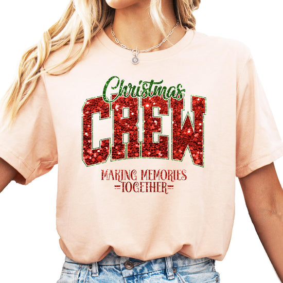 Front view of Christmas Crew faux glitter holiday tee laid flat on neutral background