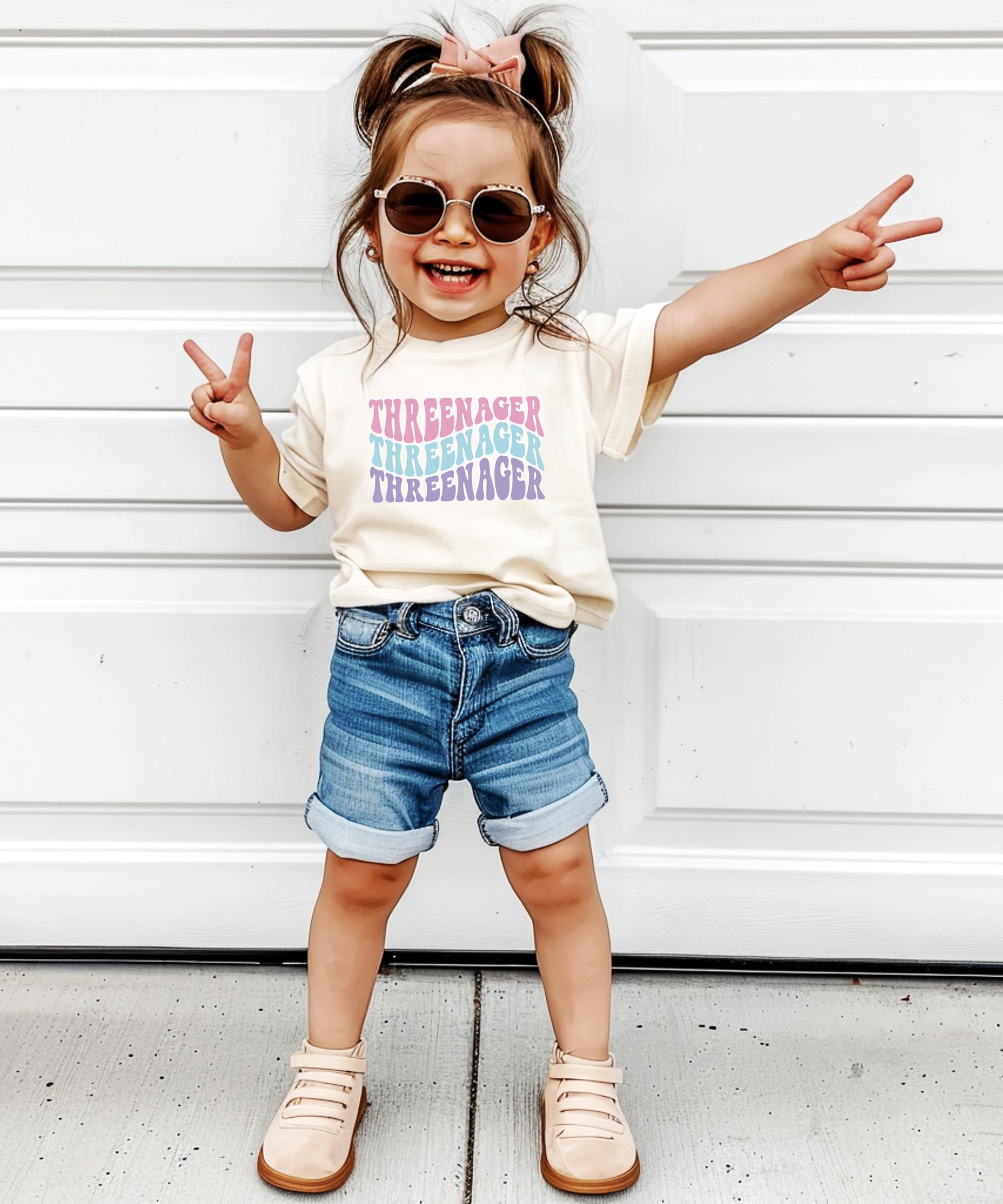 Toddler girl wearing groovy Threenager 3rd birthday shirt as birthday party outfit