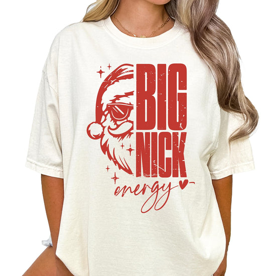 Close-up of Big Nick Energy graphic print featuring Santa in sunglasses on ivory shirt