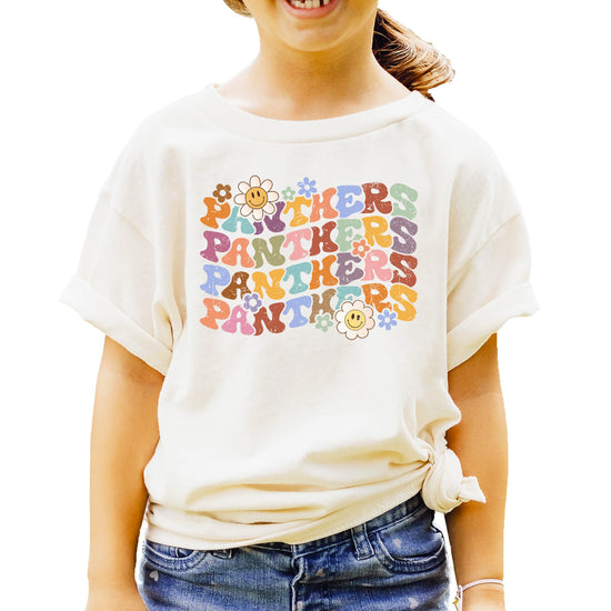 Close-up of Panthers shirt showing vintage-style wavy fonts and colorful flower graphics