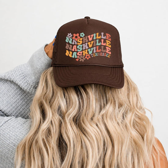 Flat lay of white Nashville Tennessee trucker hat showing full retro floral graphic and snapback closure