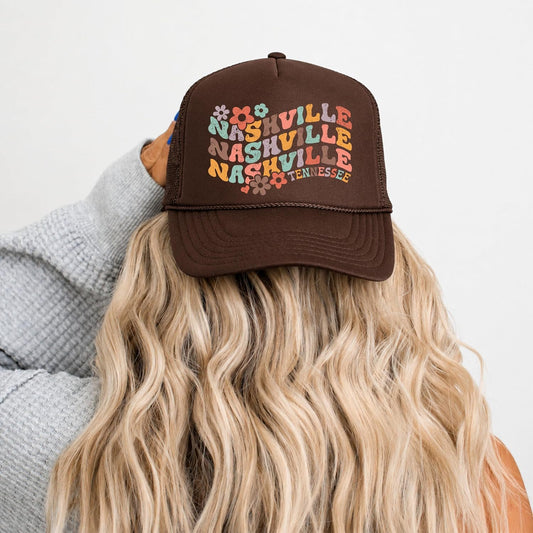 Flat lay of white Nashville Tennessee trucker hat showing full retro floral graphic and snapback closure