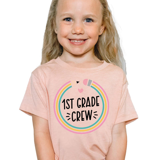 Flat lay of youth 1st grade pencil graphic tee by Olive Loves Apple