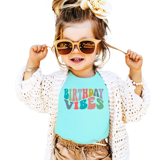 Birthday Vibes retro graphic detail on soft peach toddler birthday shirt