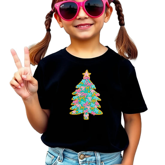 Detail shot of professional ink-printed Christmas tree with pink bow ornaments on natural kids shirt
