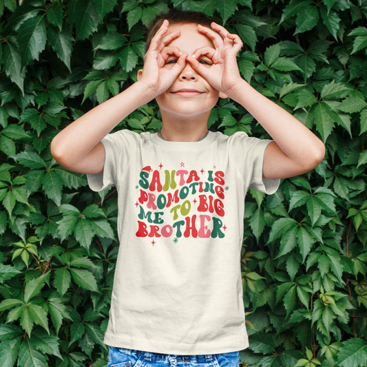Santa is Promoting Me to Big Brother Groovy Christmas T-Shirt for Baby and Toddler Youth Boy Holiday Outfit