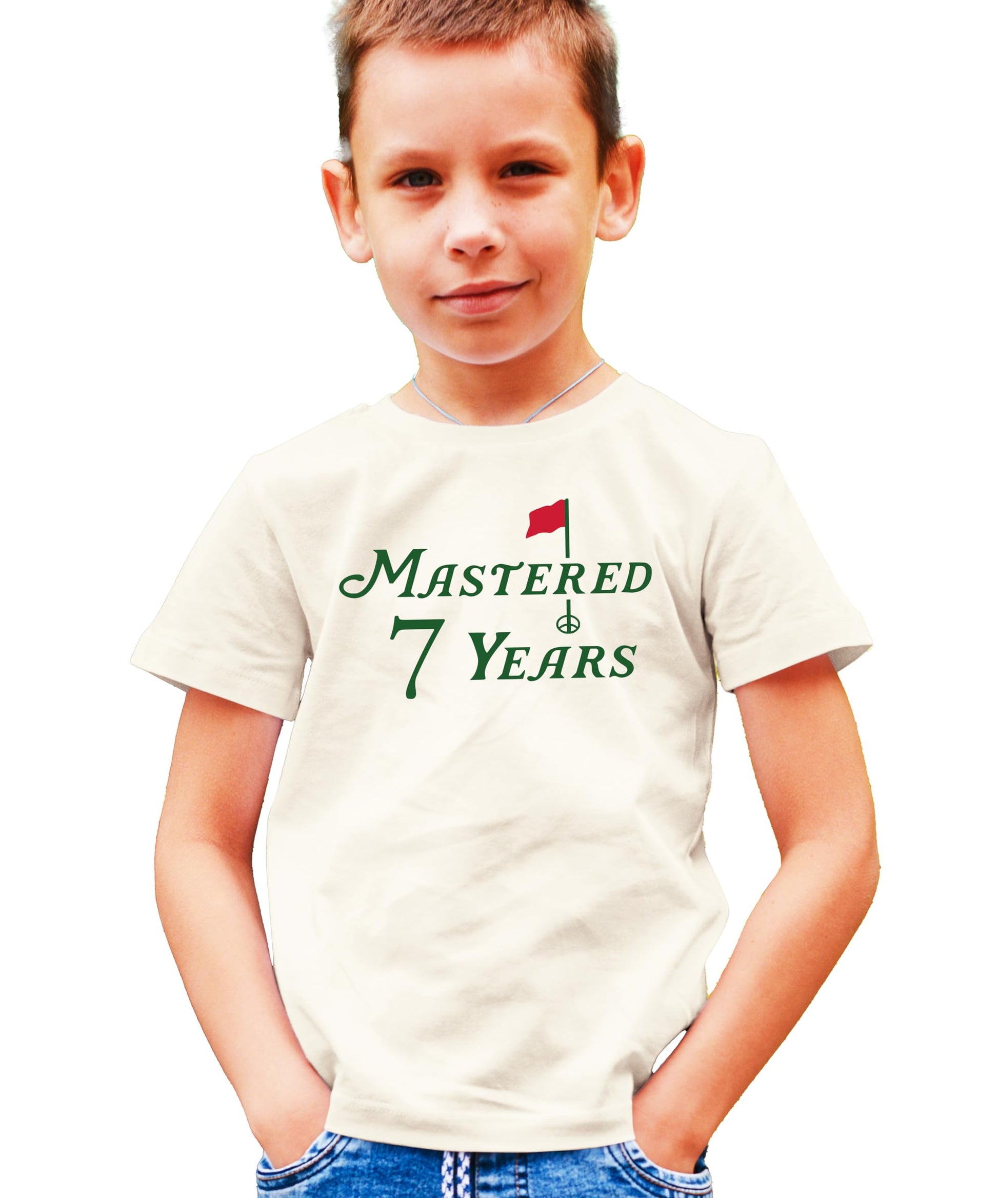 Golf themed seventh birthday shirt for kids laid flat on natural background
