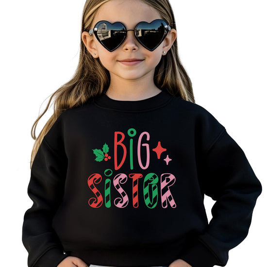 Front view of youth Big Sister Christmas sweatshirt featuring festive candy cane graphic design