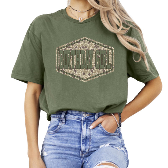 Close-up of camouflage badge graphic on natural birthday girl shirt
