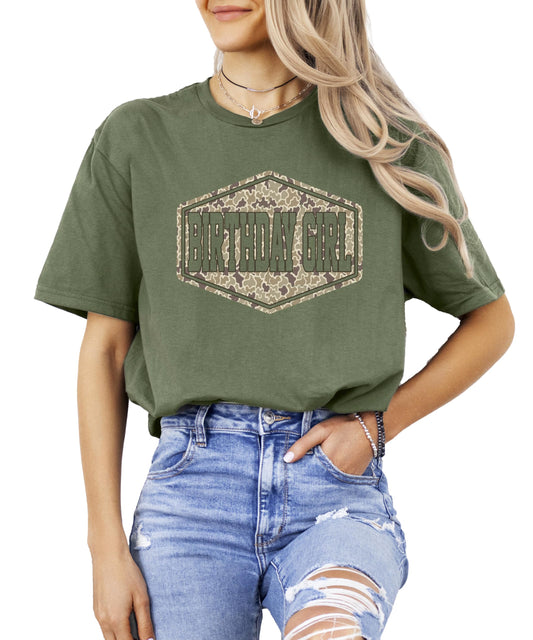 Close-up of camouflage badge graphic on natural birthday girl shirt