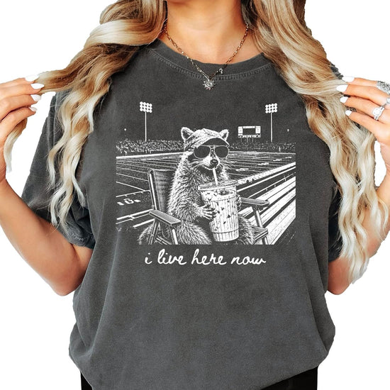 Woman wearing relaxed-fit raccoon football mom graphic tee, styled for game day