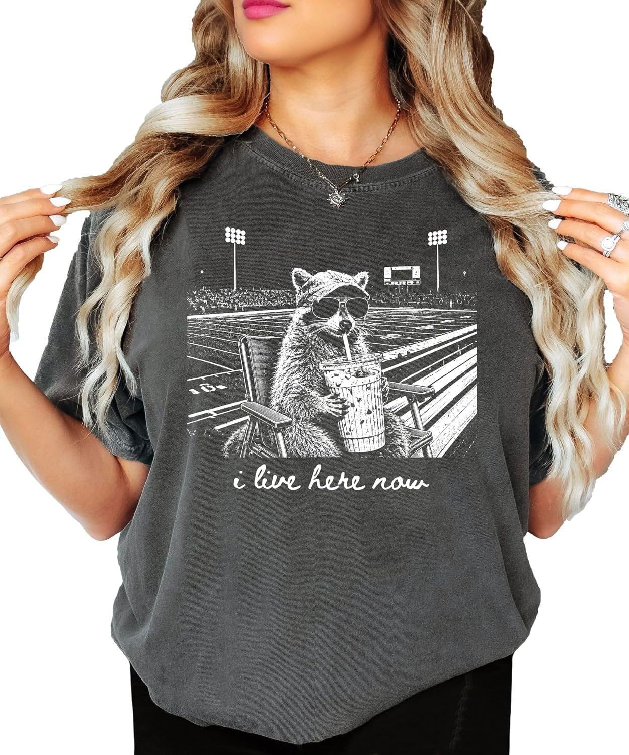 Woman wearing relaxed-fit raccoon football mom graphic tee, styled for game day