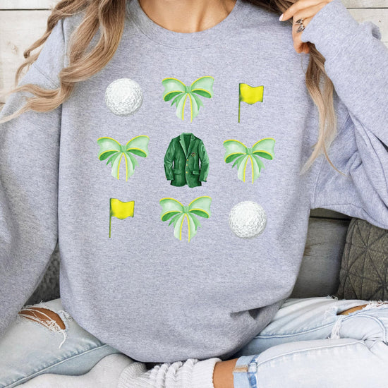 Side or alternate view of white golf pullover sweatshirt with green bow graphic print