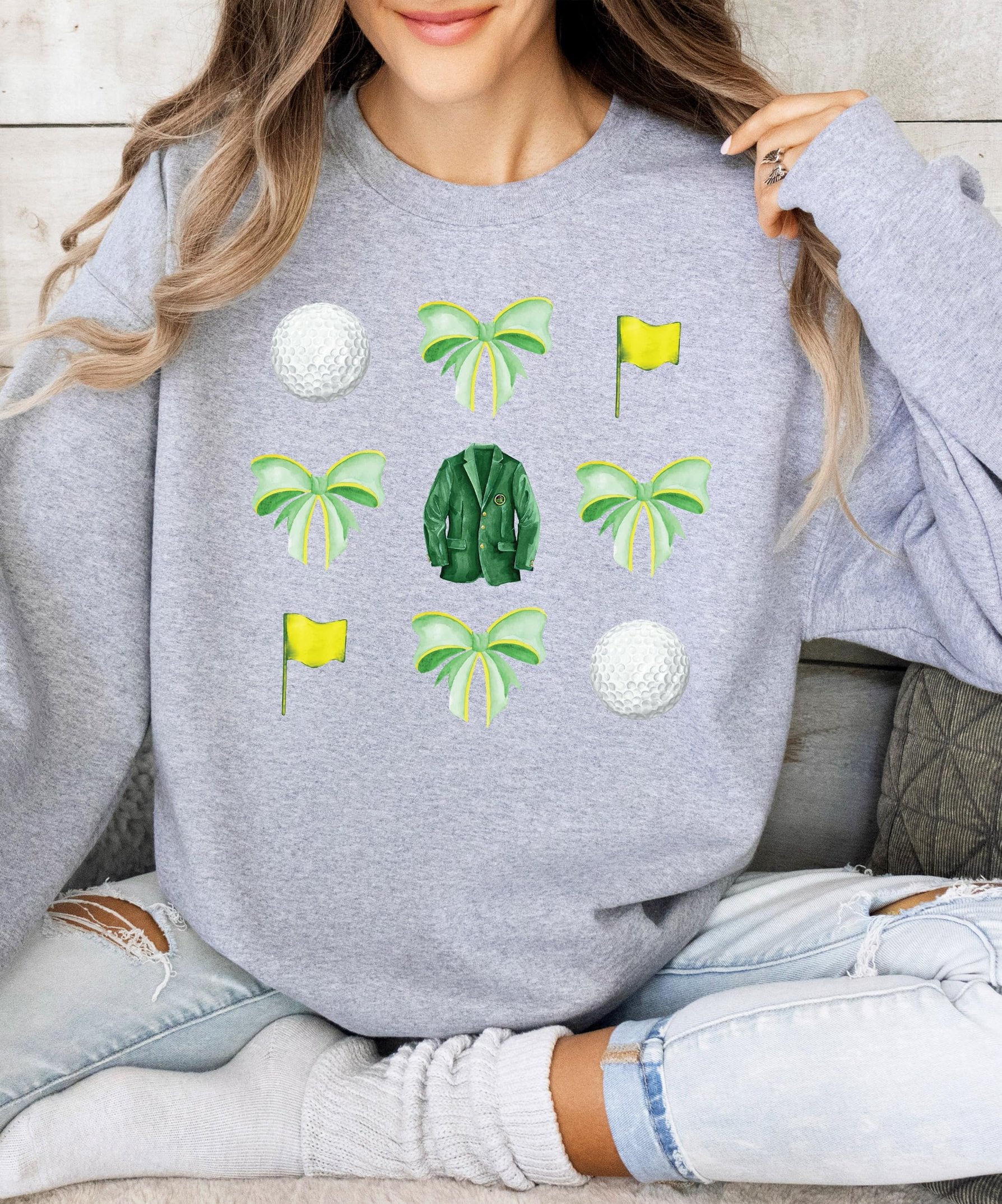Side or alternate view of white golf pullover sweatshirt with green bow graphic print