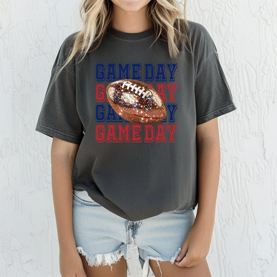 Flat lay of blue and red faux glitter football graphic game day shirt for women and teens