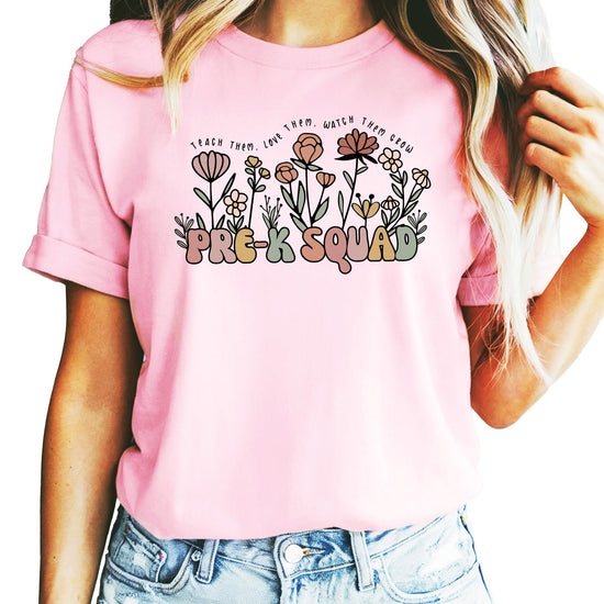 Women's peach Pre-K Squad teacher t-shirt with retro floral design and 'Teach Them Love Them Watch Them Grow' graphic