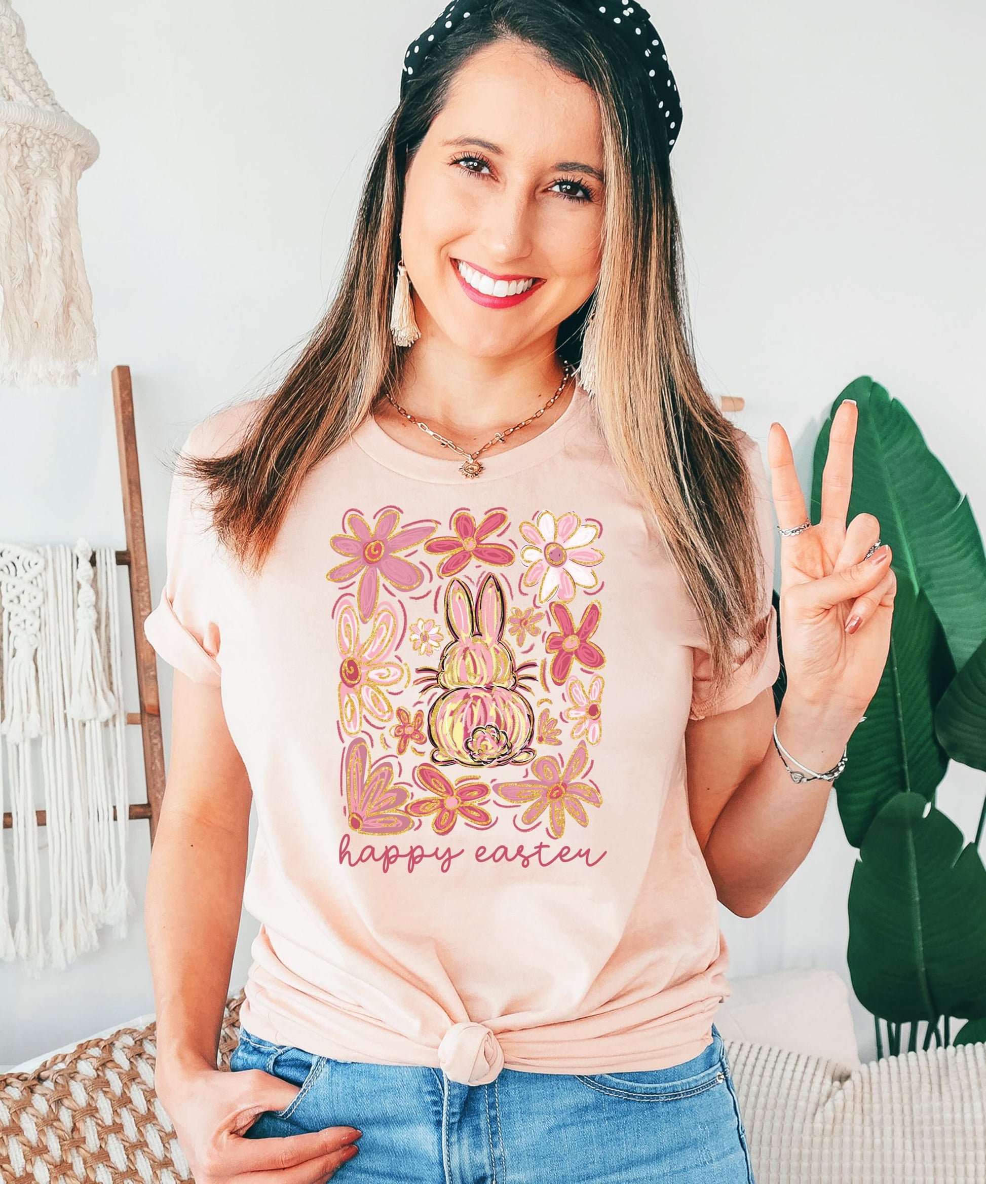 Flat lay of peach Happy Easter flower bunny shirt showing soft fabric and full graphic print — Olive Loves Apple