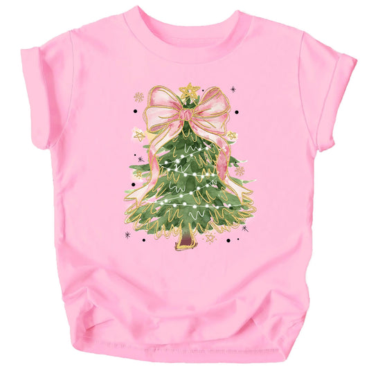 Women's peach graphic tee featuring a Christmas tree with a large pink bow topper design