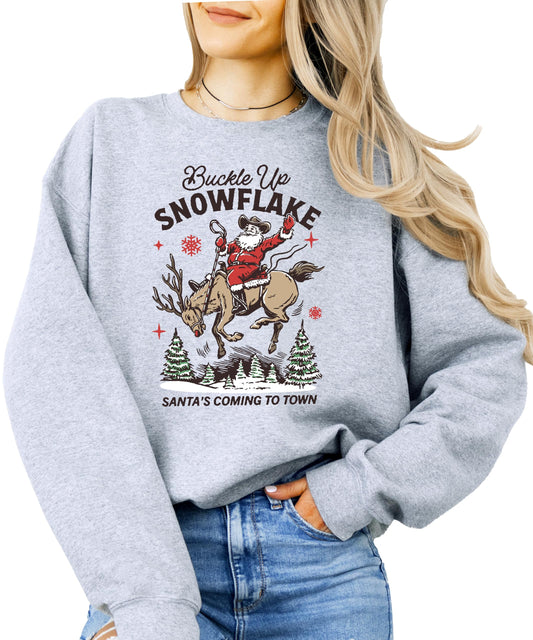Model wearing gray Buckle Up Snowflake Santa's Coming to Town Christmas sweatshirt, casual holiday style