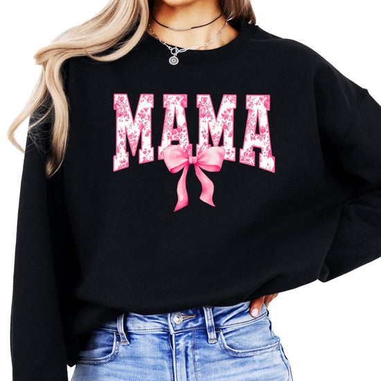 Woman wearing black Mama sweatshirt with cute pink bow design