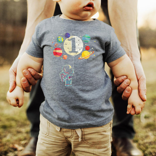 Detail shot of moon balloon and planets graphic on Olive Loves Apple 1st birthday astronaut shirt