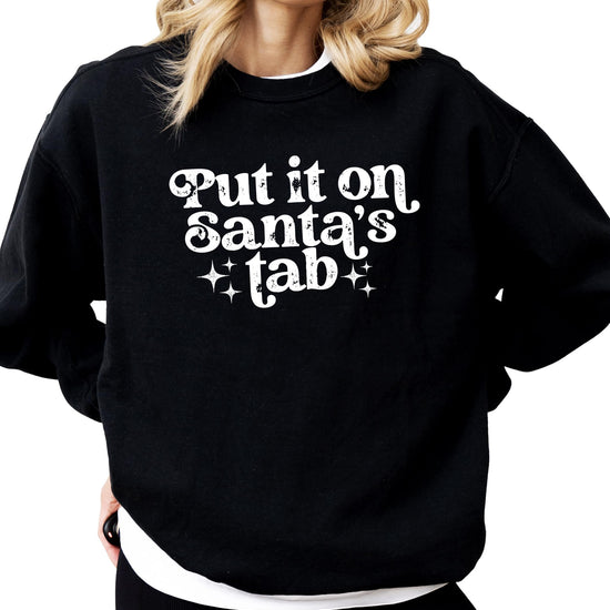 Side view of cozy red women's holiday pullover sweatshirt with funny Santa's Tab graphic