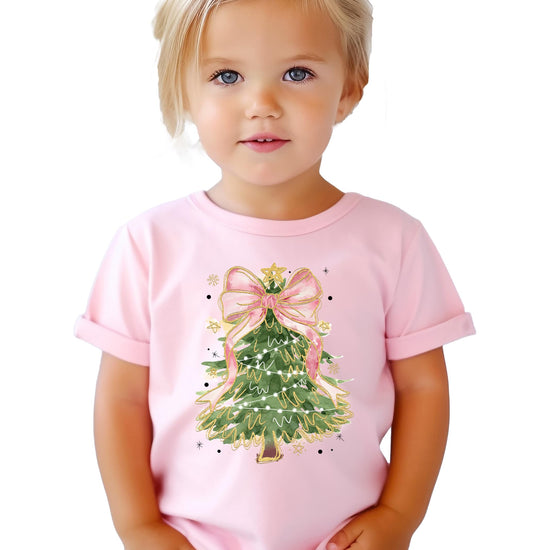 Detail shot of vibrant Christmas tree pink bow graphic print on women's holiday tee