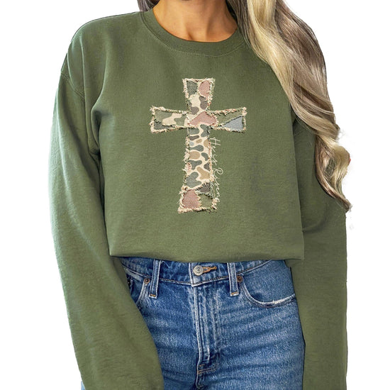 Women's camo He Is Risen cross sweatshirt with bold ink-printed graphic on army green pullover