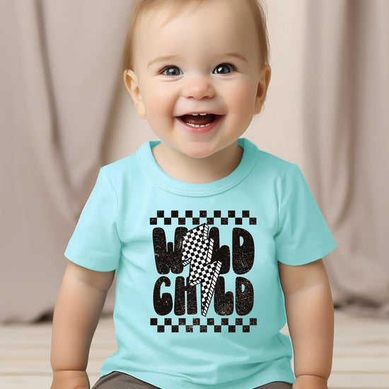 Wild Child checkered tee flat lay showing vintage-inspired design details