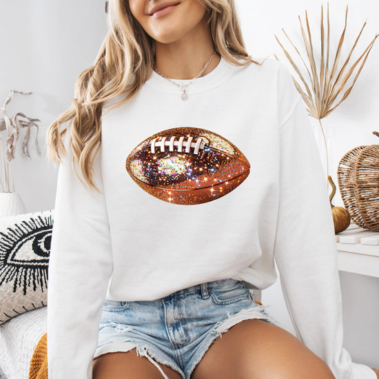 Detail shot of glitter football graphic on women's cozy pullover sweatshirt