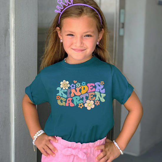 Natural kids graphic t-shirt with colorful groovy daisy kindergarten back to school print, lifestyle shot