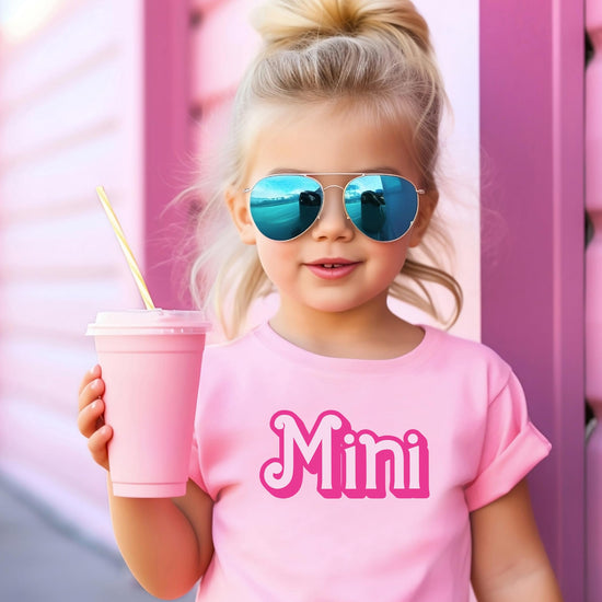 Pink mini matching tee for girls laid flat showing full graphic design