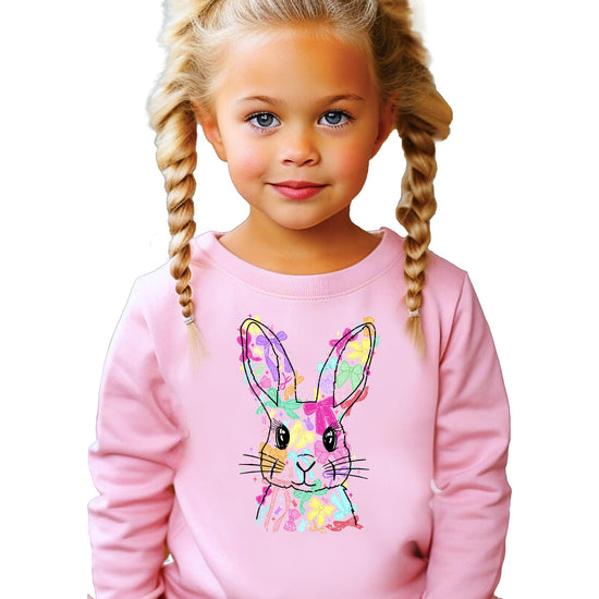 Close-up of colorful coquette bow Easter Bunny graphic print on girls white sweatshirt