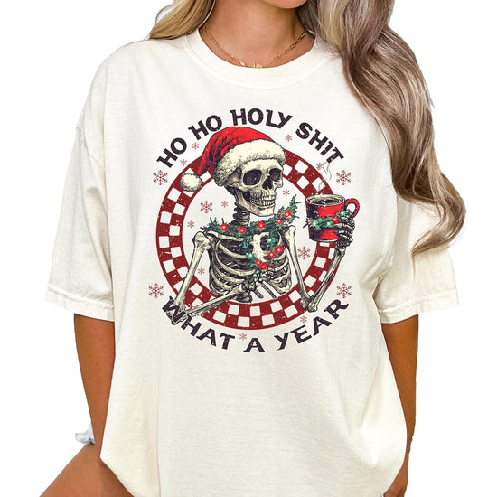 Flat lay of Ho Ho Holy Sh*t What a Year funny Christmas skeleton graphic tee