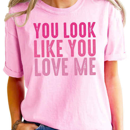 Close-up view of You Look Like You Love Me text graphic on black women's t-shirt