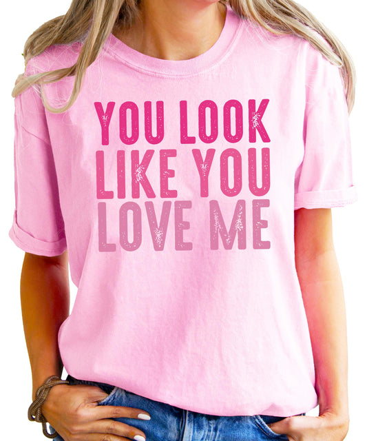 Close-up view of You Look Like You Love Me text graphic on black women's t-shirt