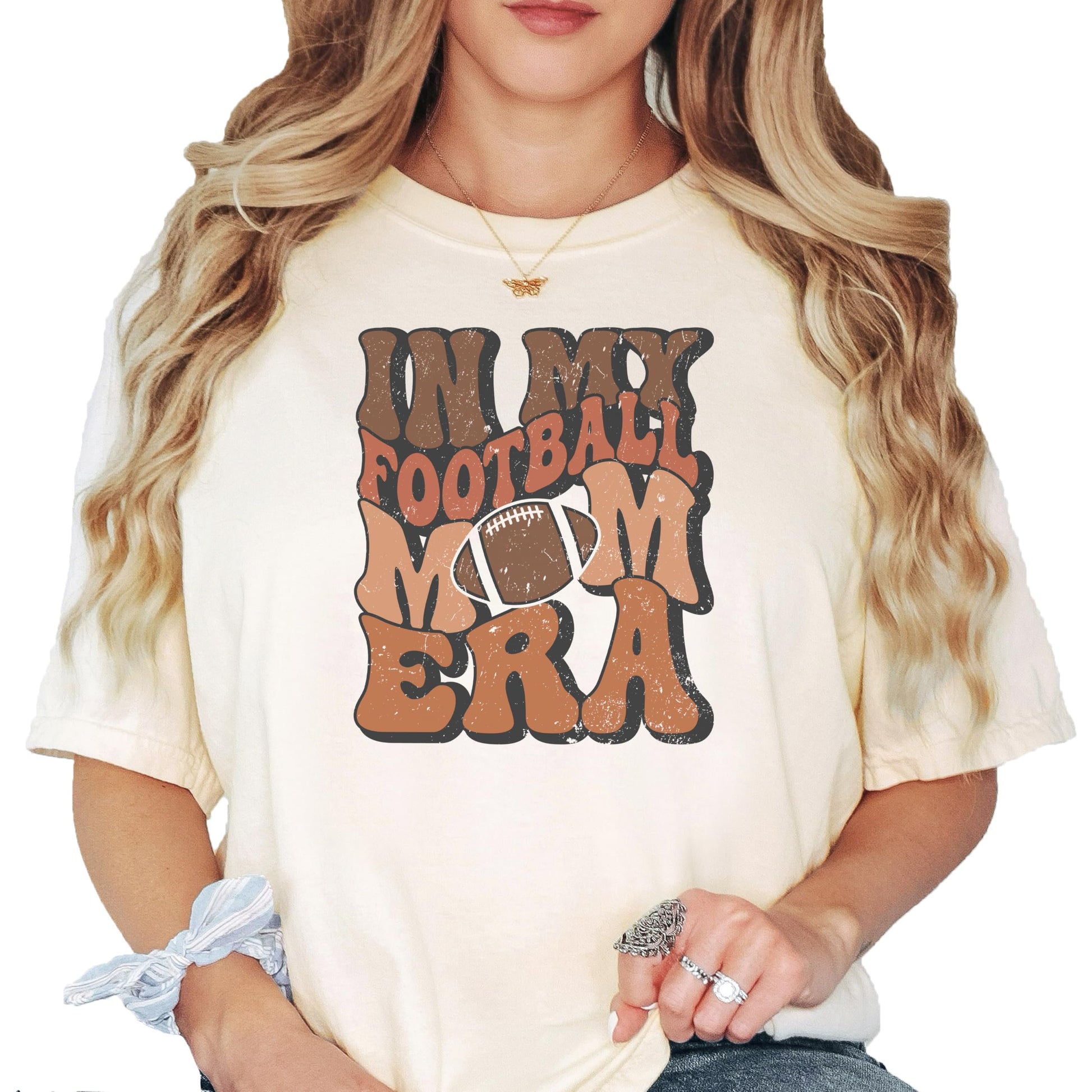 Ivory 'In My Football Mom Era' graphic t-shirt with vintage-style text design, front view