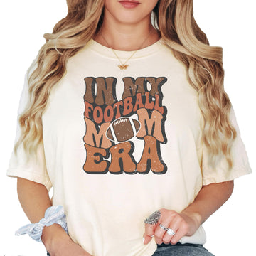 Ivory 'In My Football Mom Era' graphic t-shirt with vintage-style text design, front view